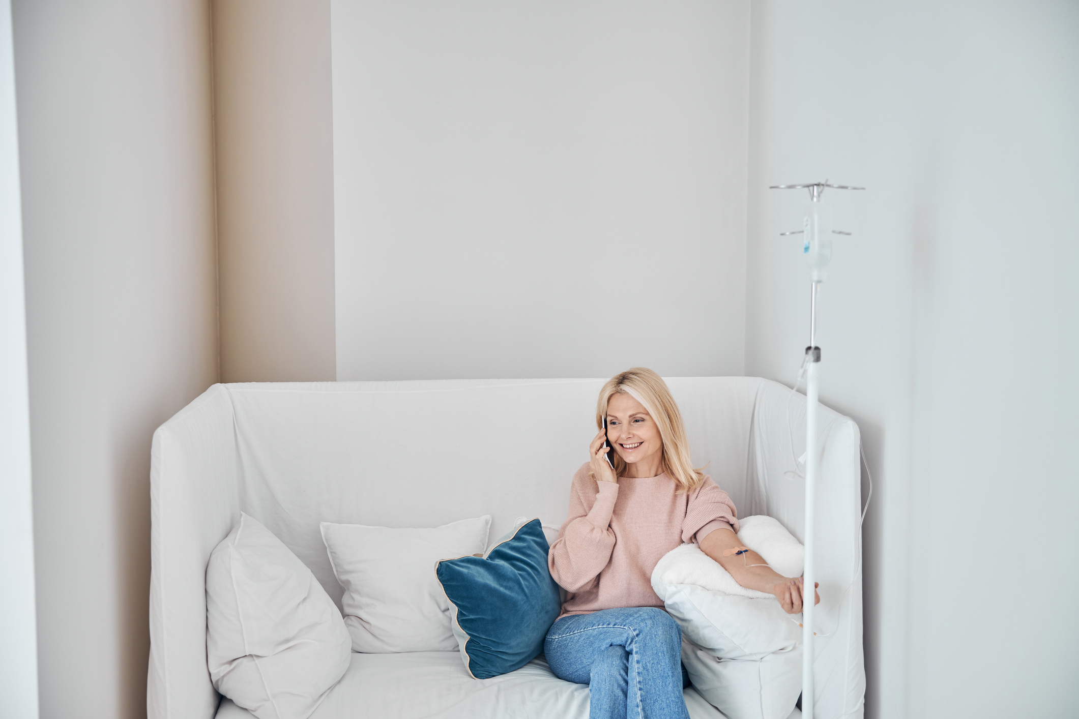 patient talking on the phone while receiving IV therapy