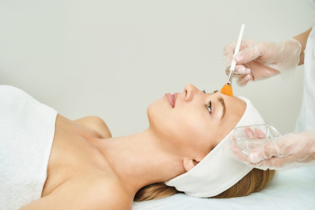 Aesthetician applying peeling facial